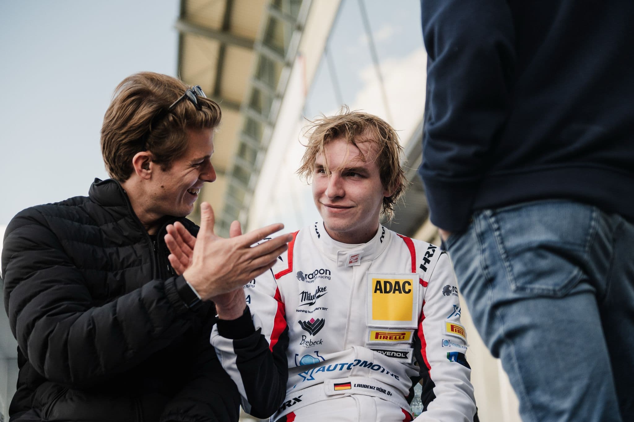 Joshua consulting with professional racing driver