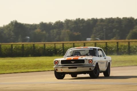 Joshua consulting with professional racing driver